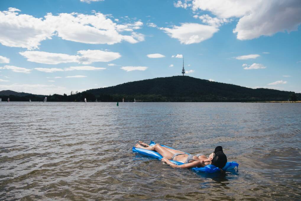 Canberrans are returning to the lake. Kelly Dixon of Lyneham sunbaths on the water earlier this month. Photo: Rohan Thomson