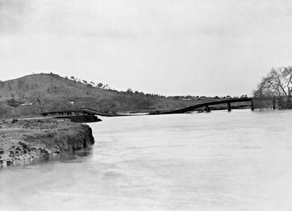 The railway bridge across the Molonglo River near Jerrabomberra Wetlands, shortly after it was destroyed in the 1922 flood (Mt Pleasant at left). Photo: National Archives of Australia
