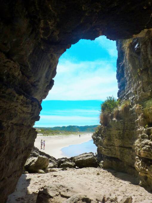 Peering out of the large cavern at Booderee's Cave Beach. Photo: Tim the Yowie Man