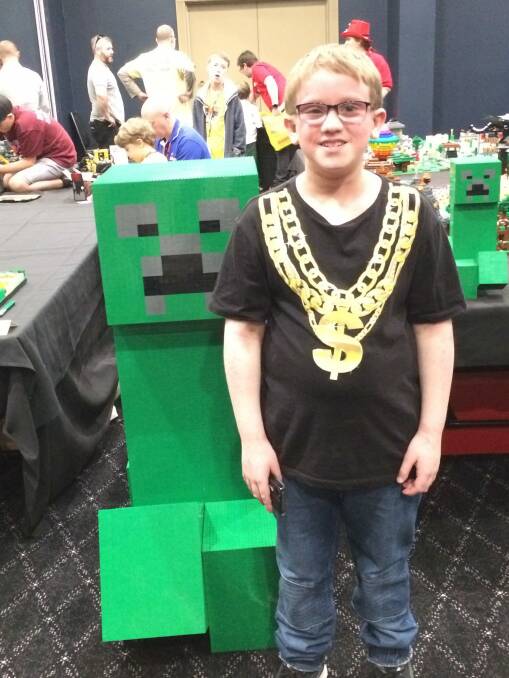 Oscar Williams, 11, of Florey with the massive Minecraft Lego creeper at Brick Expo at the Hellenic Club. Photo: Megan Doherty