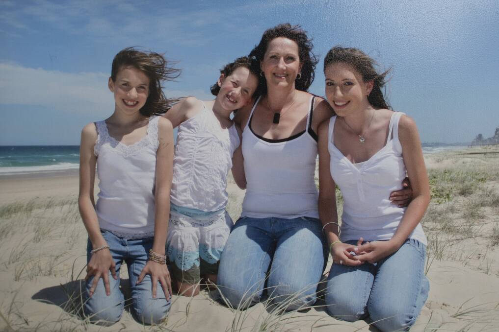 Single mum Di with her daughters (from left) Kellie, Melanie and Sarah before two severe strokes upended her life. Photo: Supplied