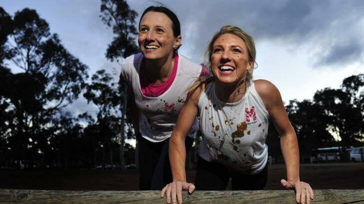 From left, Sharon Moloney of O'Connor and Rochelle Riley of Casey preparing for Miss Muddy, an obstacle course fitness event on at Exhibition Park in Canberra on October 19. Photo: Melissa Adams