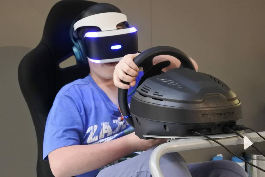 Josh Moody, 14, tries out the Playstation VR headset at Westfield Belconnen. Photo: Stephen Jeffery