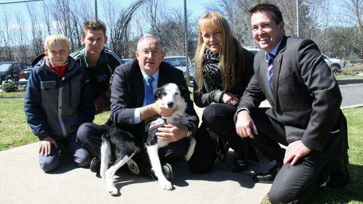 Graduation: Dogs For Diggers graduate 'Jakey' surrounded by politicians and recipients.