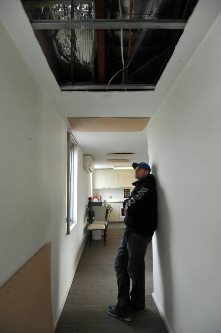 Gaping holes in the ceiling of Grant Seears' apartment are causing the heat to escape. Photo: Graham Tidy