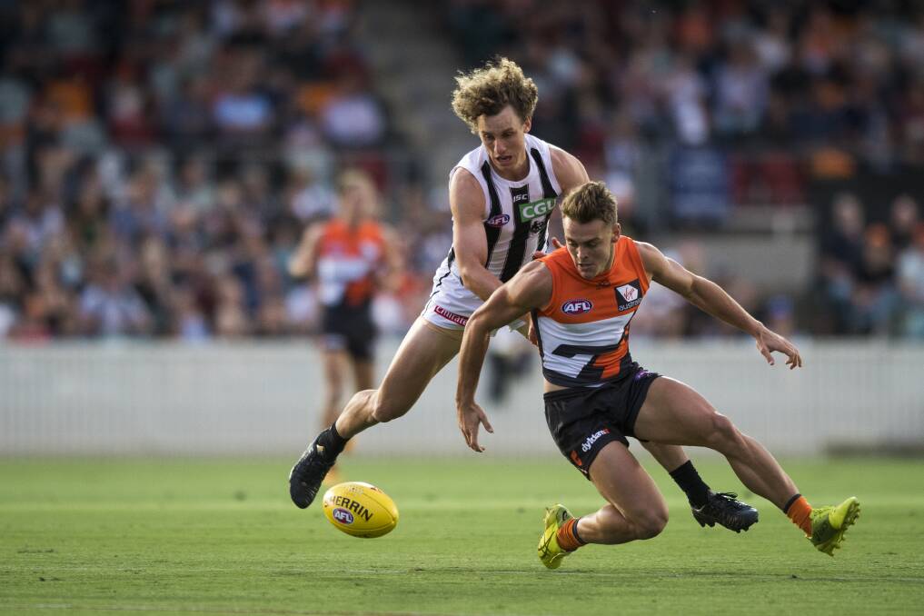 AFL Pre-Season Game: GWS Giants Vs Collingwood Magpies 2018. Zac Langdon tries to grab the ball. Photo: Dion Georgopoulos