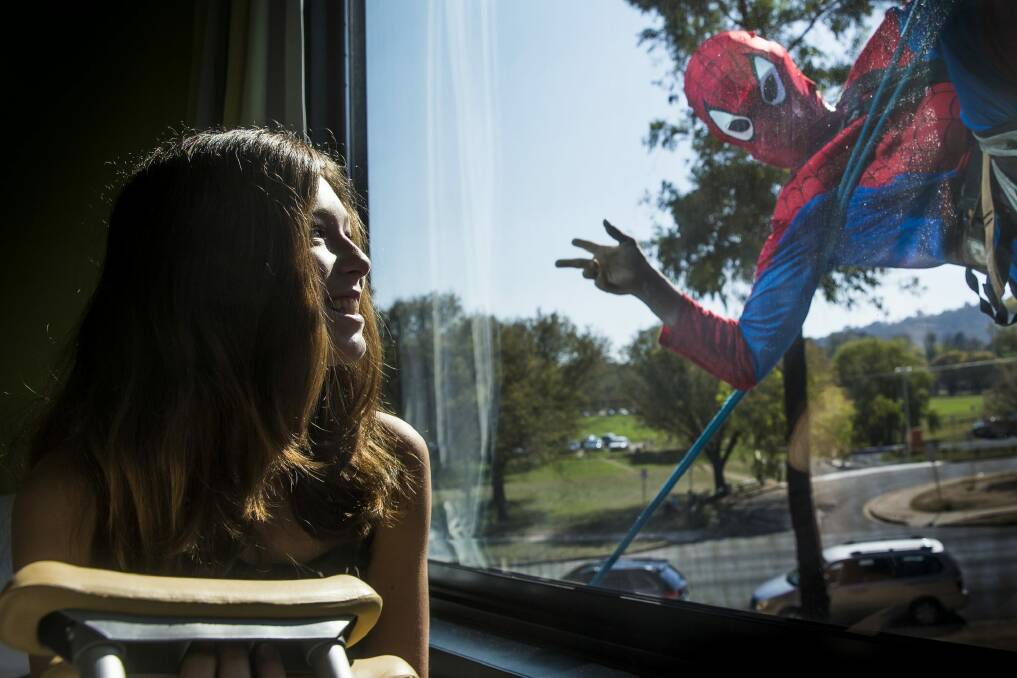 Kaylah Field, 12, gets a visit from Spiderman. Photo: Matt Bedford
