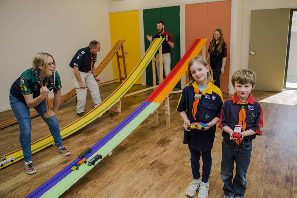 Scouts Tasmyn Houghton 8, and Hamish Laner 7, enjoy their new hall with encouragement from Julia Clark, 14, group leader Tony Houghton, Jesse Moores, of Lake Ginn Rover crew, and Eliza Lane, 16. Photo: Jamila Toderas