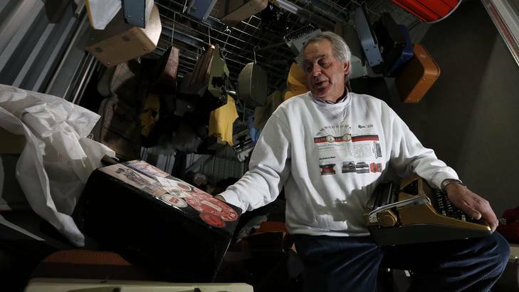 Canberra Times journalist Robert Messenger searches through part of his collection of more than 900 typewriters at his storage unit. Photo: Jeffrey Chan