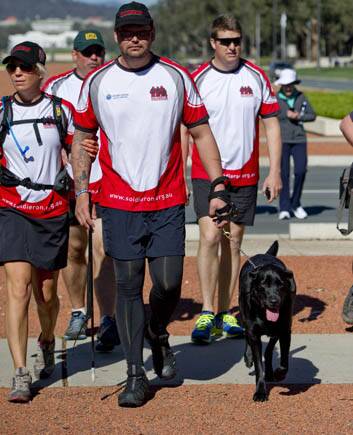 Private Liam Haven with guide dog Owen walks down ANZAC Parade to complete his trek to raise money and awareness for contemporary veterans' charity Soldier On and Guide Dogs Victoria. Photo: Jay Cronan