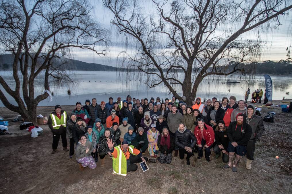 Participants in the winter solstice swim on the shores of Lake Burley Griffin, before they stripped off to swim nude for charity. Photo: Karleen Minney