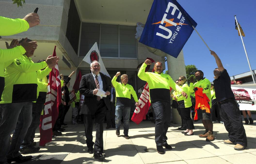 CFMEU organiser Johnny Lomax (right) exits the ACT Magistrates Court after the case against him collapsed in October 2015. Photo: Graham Tidy