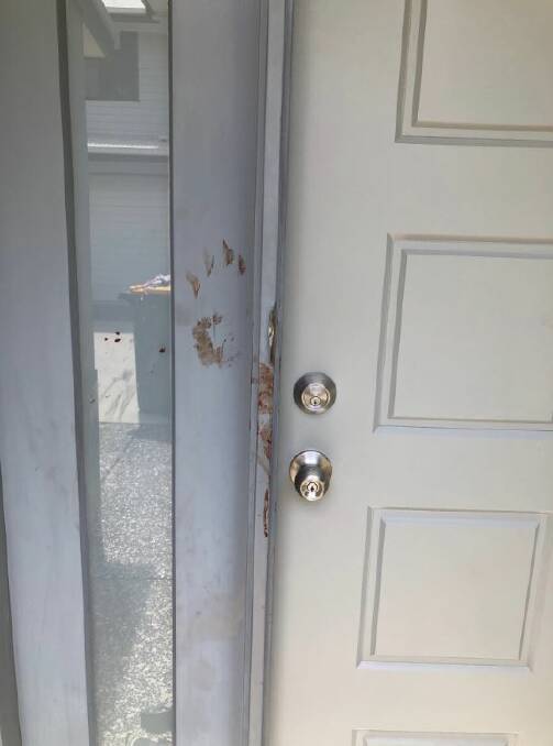 Blood was smeared on the door with hand prints after a teenage girl was stabbed multiple times in a Wynnum home. Photo: Emily Prain, Nine News