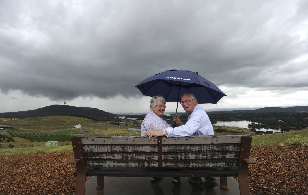 Barbara and Ric Kells, of the Blue Mountains, came prepared for wet weather at the National Arboretum. Photo: Graham Tidy