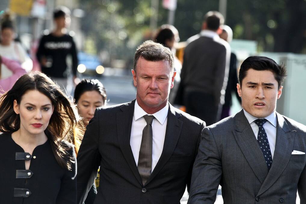 Anthony Bell arrives at court last week flanked by his legal team. Photo: Ben Rushton