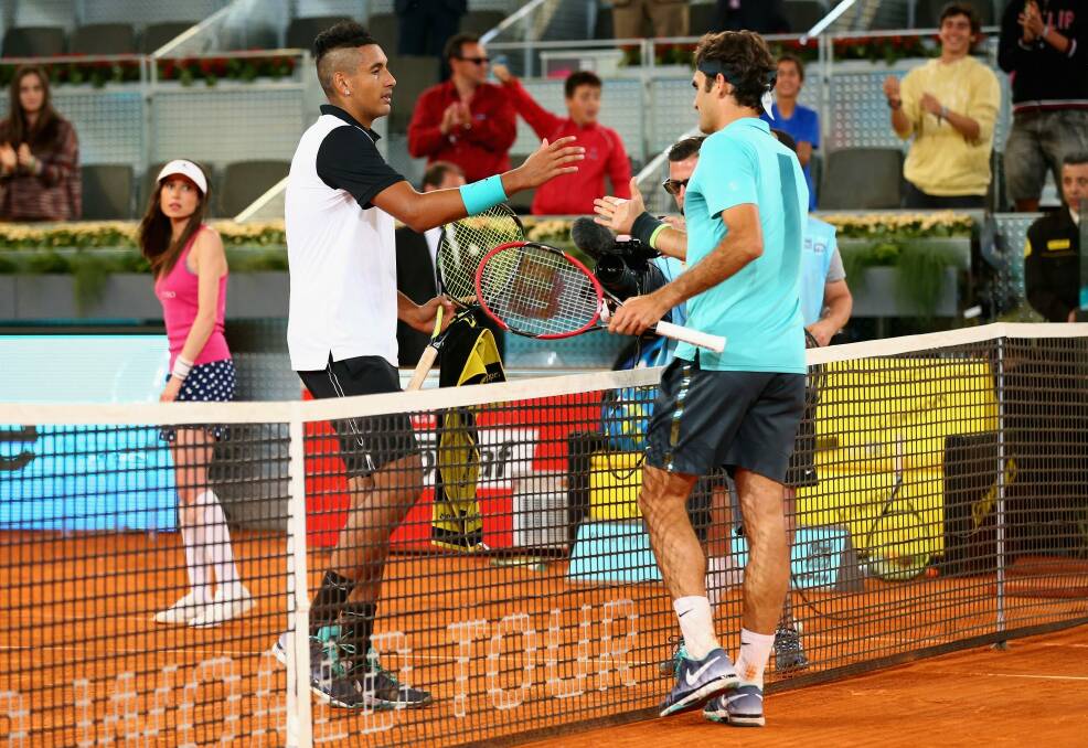 Kyrgios and Federer shake hands after the Canberran's three set victory. Photo: Getty Images