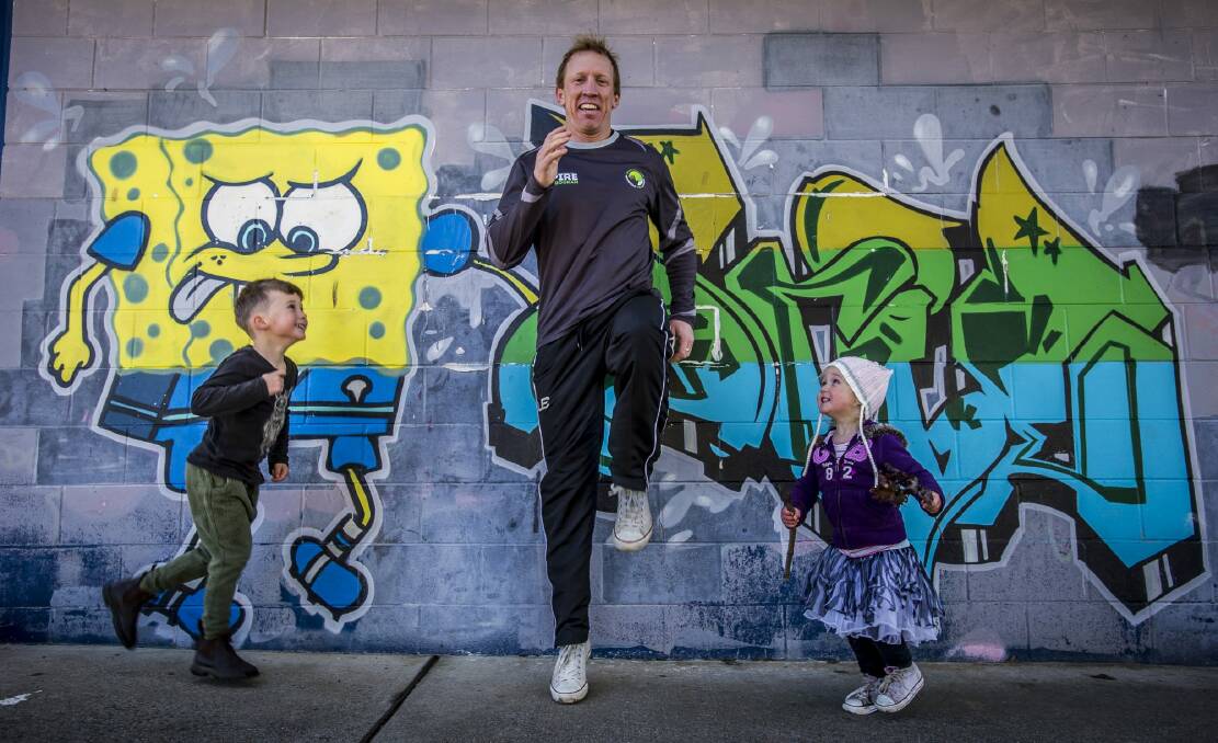 Former NRL Raiders captain and fitness guru Alan Tongue (pictured with his children Gem, 5, and Lola, 2) encourages fathers to participate in the Canberra Times Fun Run with their children. Photo: Karleen Minney