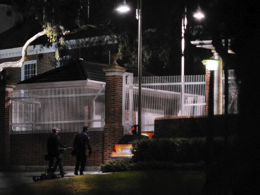 Bomb response team inspect the vehicle wedged in the entrance gate to the US embassy in 2013. Photo: Graham Tidy