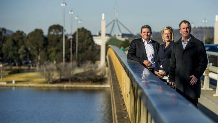 Authors and journalists Chris Uhlmann and Steve Lewis with Chief Minister Katy Gallagher on Commonwealth Bridge where a mini-series based on their books will be shot. Photo: Jay Cronan