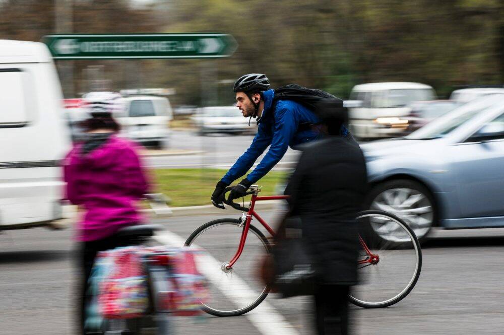 A cyclist travels down Northbourne Avenue in Braddon in peak-hour traffic. Photo: Rohan Thomson