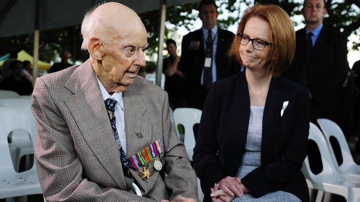 Prime Minister Julia Gillard talks with former P.O.W Sidney King at the dawn service in Townsville. Photo: Getty Images