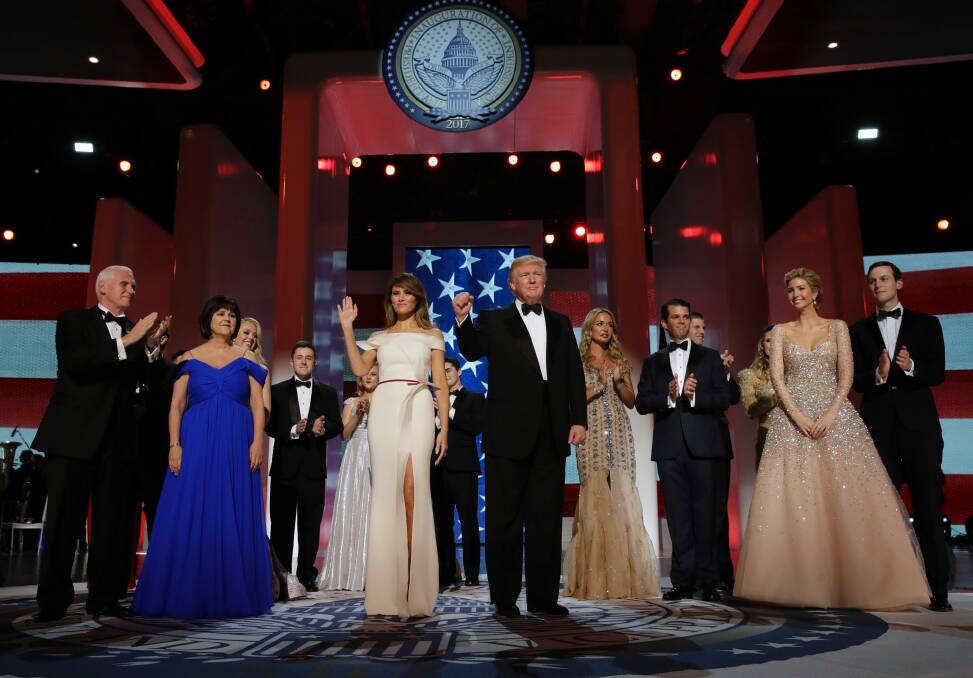President Donald Trump acknowledges the crowd with First Lady Melania Trump, Vice-President Mike Pence and his wife Karen, left, and their families at the Freedom Ball. Photo: AP
