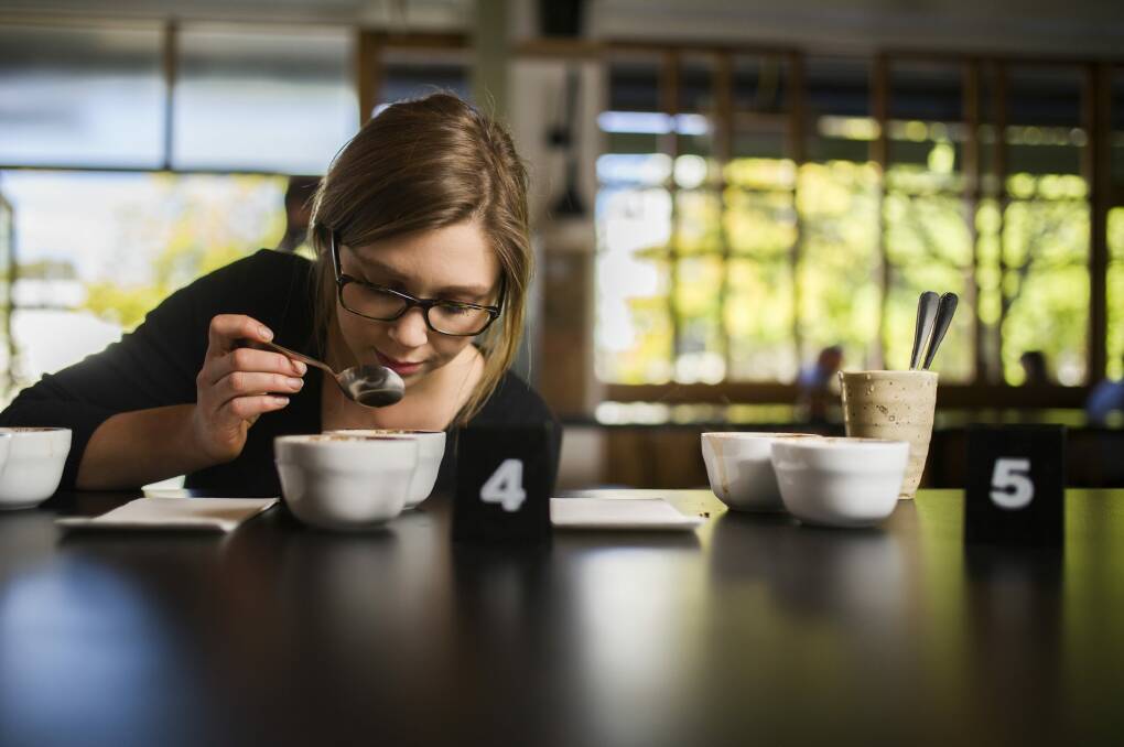 Head barista Caity Reynolds at The Cupping Room in Civic Caity Reynolds tastes coffee for flavour. Photo: Rohan Thomson