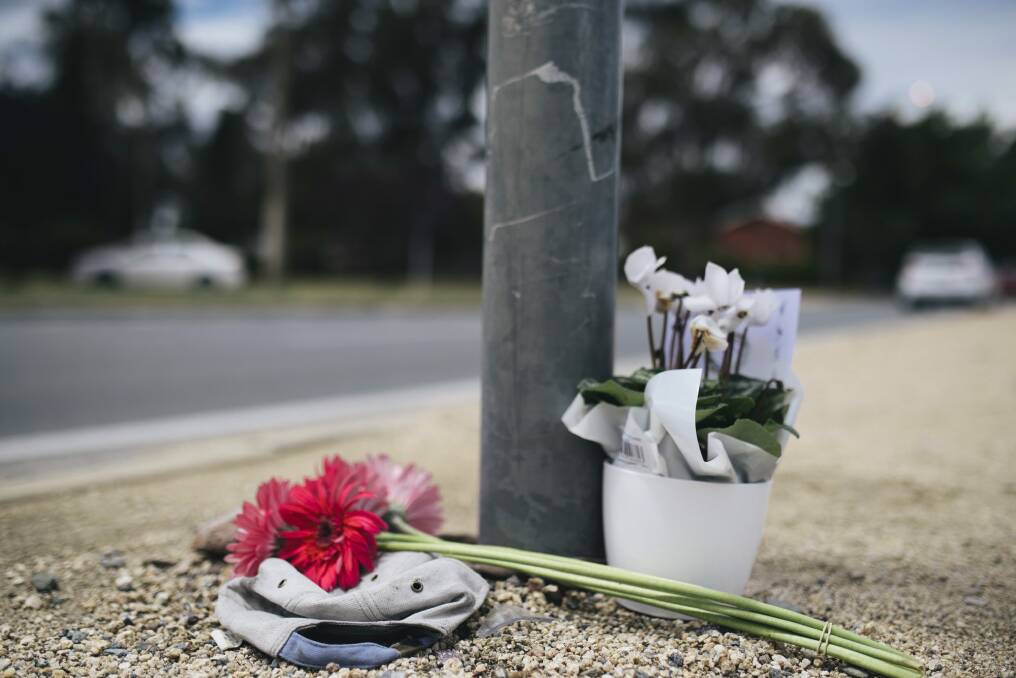 Flowers have been left at Ian 'Scrubby' Stokes' spot at the Northbourne Avenue and Antill Street intersection where he washed windscreens for many years. Photo: Rohan Thomson