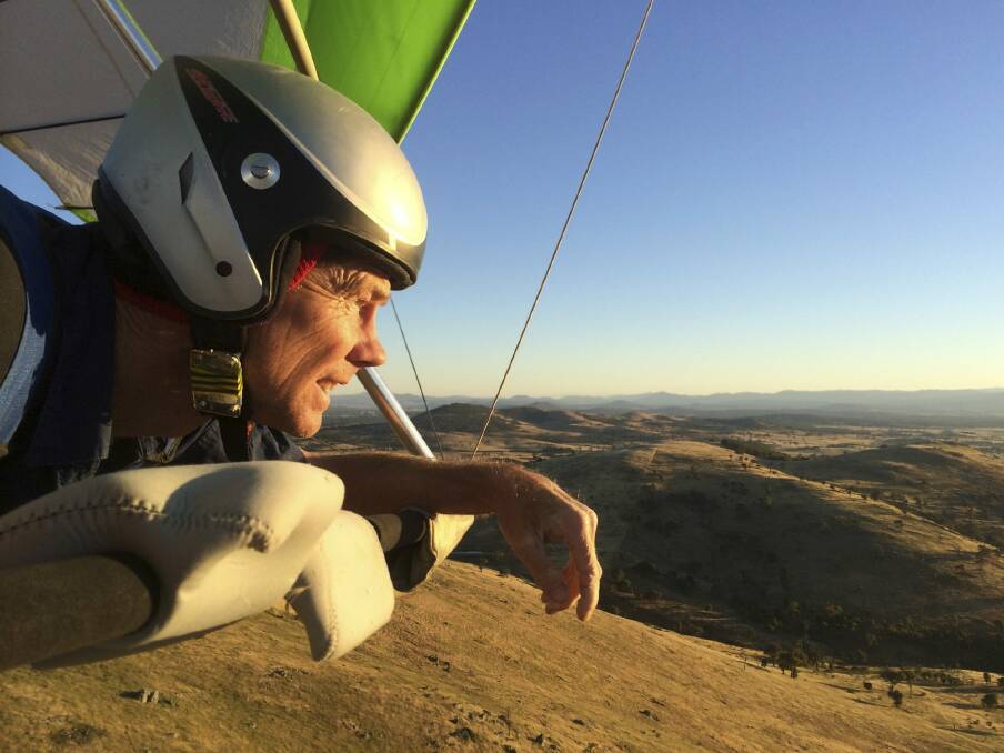 Paraglider Phil Robinson in the sky above Spring Hill near Hall.