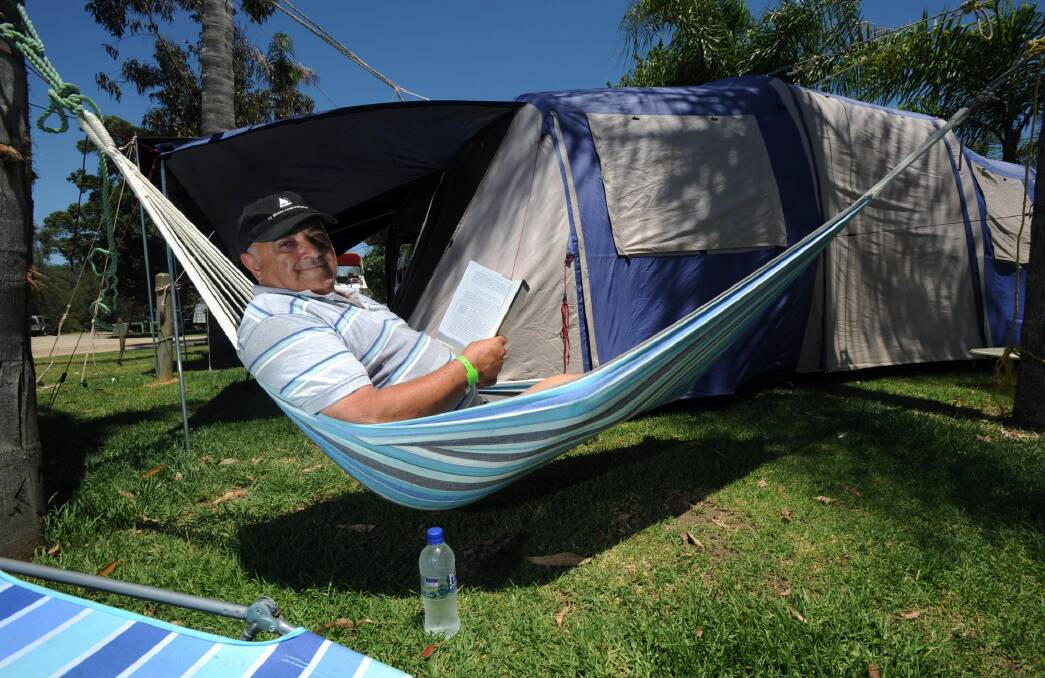 Chill time: Colin Watego relaxes outside his family tent at the Big 4 Nelligen Holiday Park on the Clyde River near Batemans Bay.  Photo: Graham Tidy
