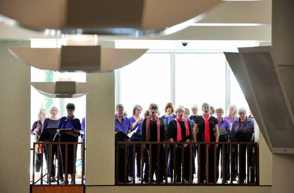 Community oratorio: The Chorus of Women performing on the 10th anniversary of the start of the Iraq War at the front balcony of Parliament House in 2013.  Photo: Colleen Petch