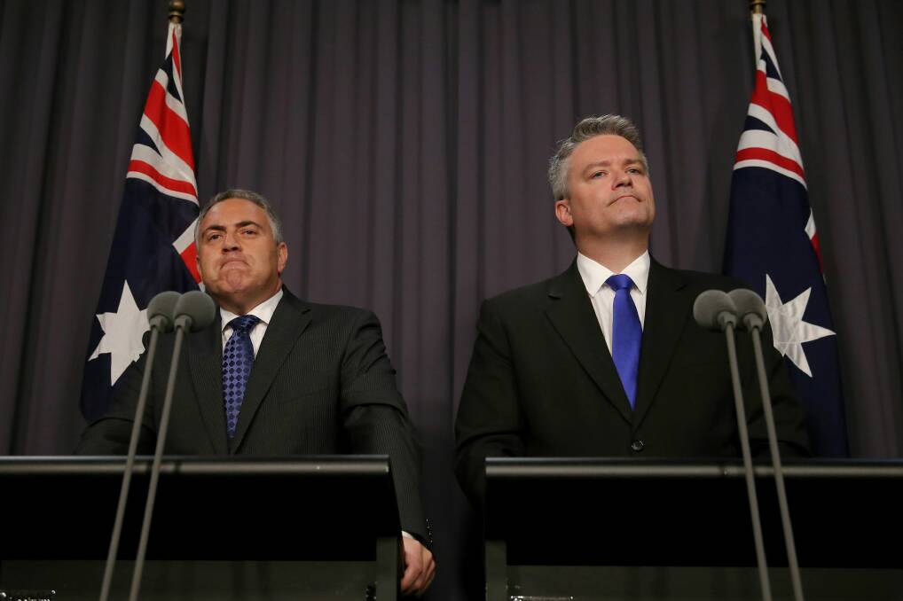 Keeping mum: Joe Hockey and Mathias Cormann have apparently ended their war on public service jobs ... but a surprise is buried in the budget's outlying years. Photo: Alex Ellinghausen