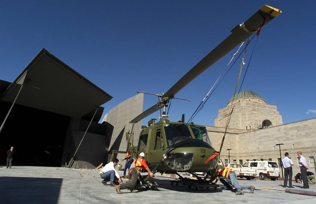 A picture from 2001 showing an Iroquois helicopter from the Royal Australian Air Force that flew in Vietnam in 1966 being transported by truck to the then-new Anzac Hall at the rear of the Memorial. Photo: Paul Harris 