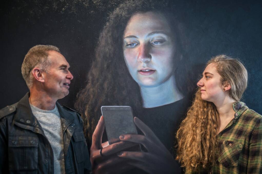 Gordon artist Ross Townsend   with daughter Hannah and her portrait, Social Event. Photo: Karleen Minney