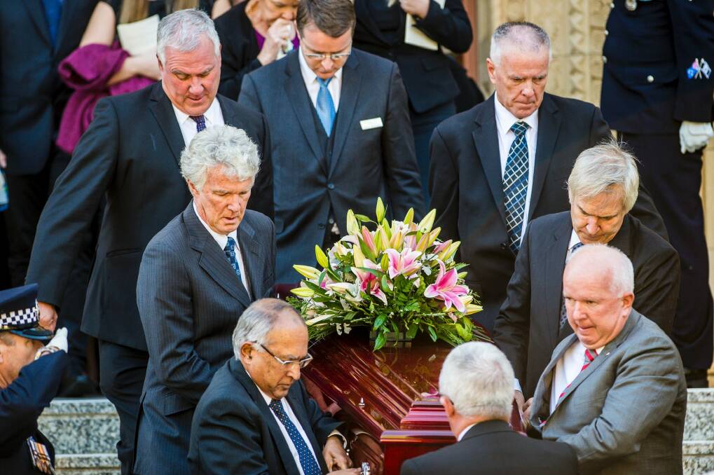 The pallbearers for Sir Peter Lawler included his sons Michael, John, Peter, Anthony and Christopher Lawler, and Philip Muttukumaru. Photo: Sitthixay Ditthavong