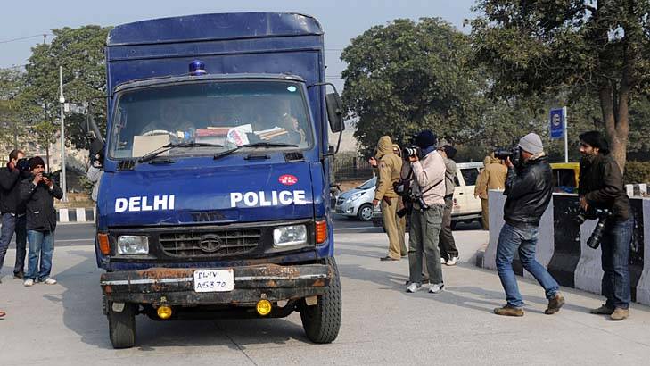Police drive the vehicle believed to be carrying the accused in a gang rape and murder case. Photo: AFP