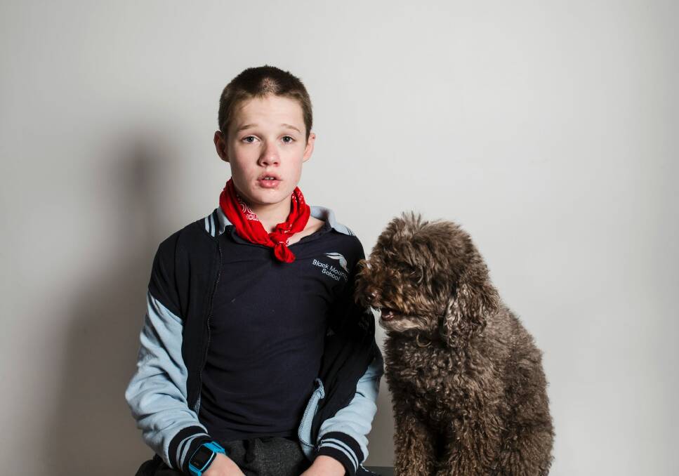 16-year-old Logan with his therapy dog Simi. Photo: Jamila Toderas