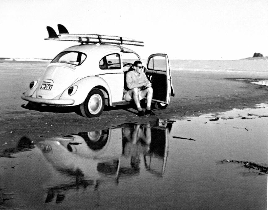 The front cover of Ian Ingram's book Capital Surfers features this photograph of Ian Ingram in his VW Beatle parked on Narooma main surf beach in 1964. Photo: Supplied