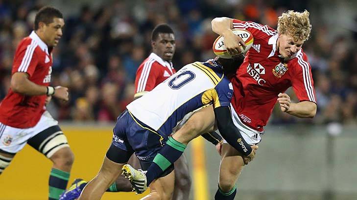 Crashing back to earth: Billy Twelvetrees of the Lions is tackled by Matt Toomua. Photo: Getty Images
