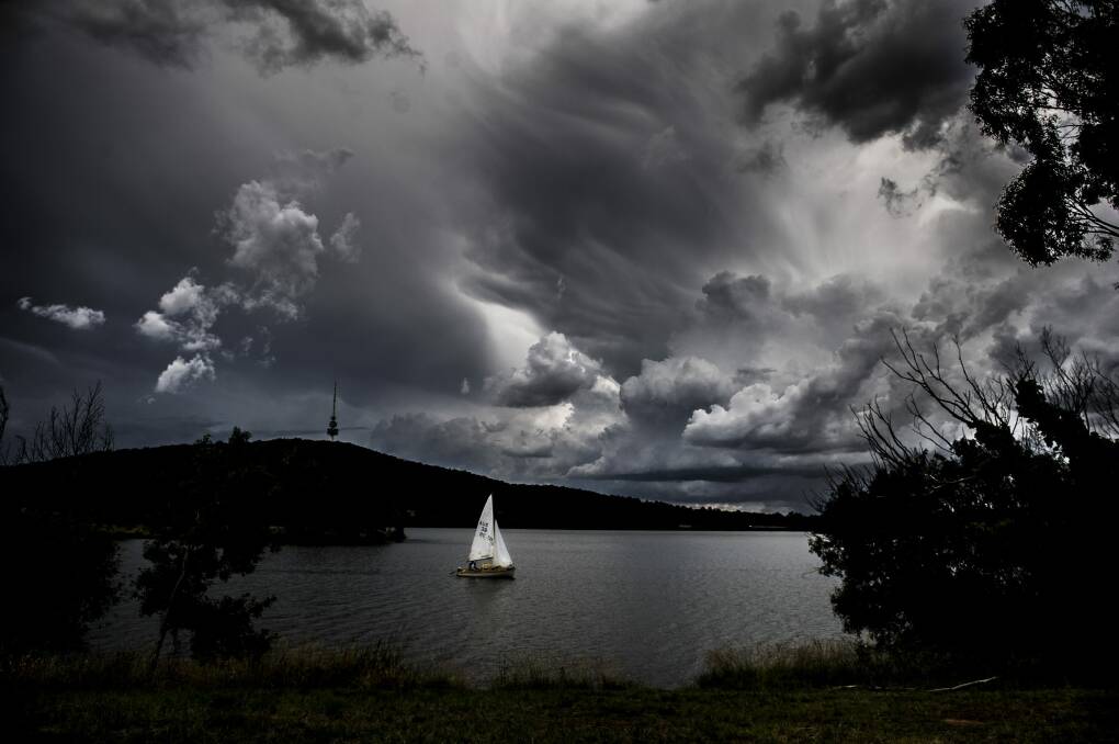 Change is in the wind: A sailing boat takes to Lake Burley Griffin under ominous skies on Friday. Climate predictions say Canberra can expect an increase in bushfire risks in Summer and Spring. Photo: Jay Cronan