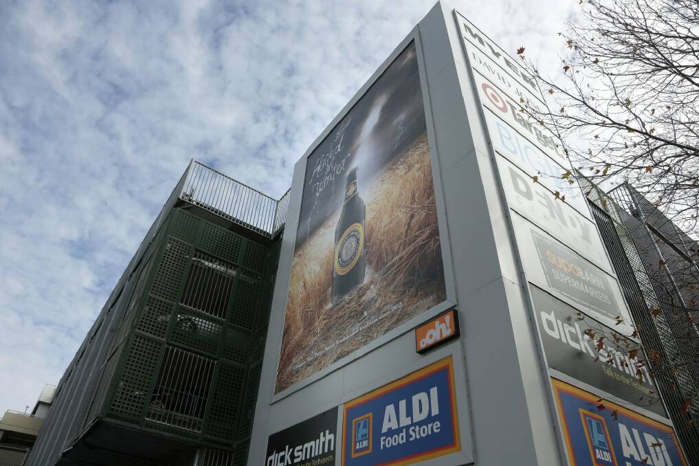 Advertisements for beer and Canberra Centre stores on the outside of the building. Photo: Jeffrey Chan