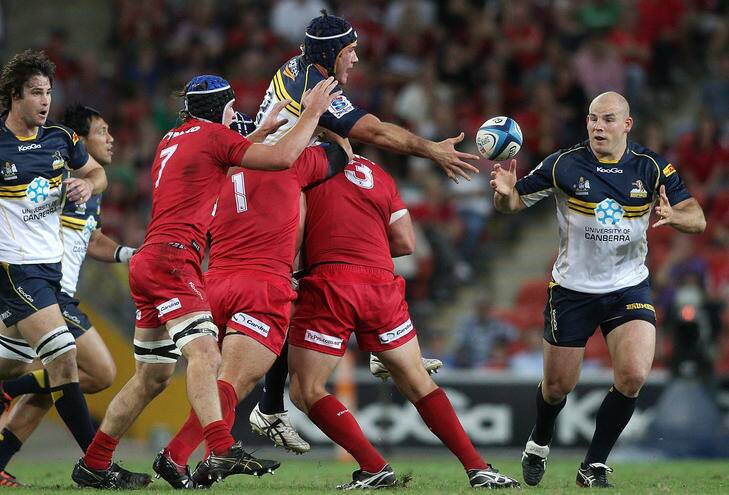 Ben Mowen of the Brumbies offloads during the round seven Super Rugby match between the Reds and the Brumbies at Suncorp Stadium on Friday. Photo: Bradley Kanaris