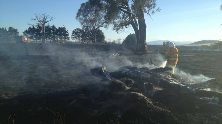 Fire fighter mopping up at  Wallaroo. Photo: Christopher Knaus