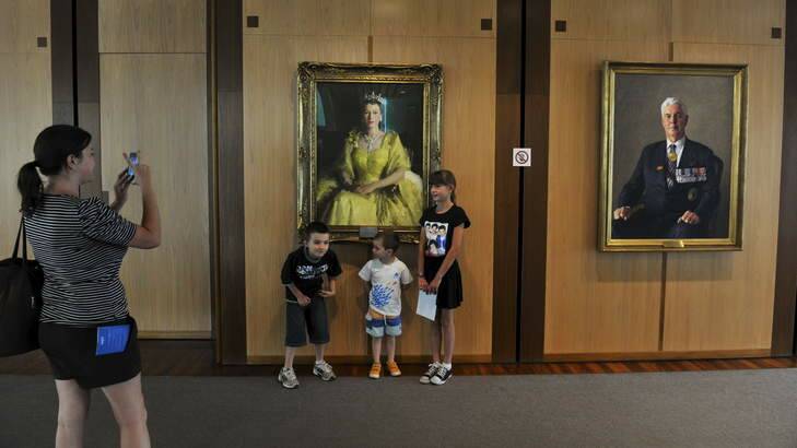 No barrier ... Gundaroo visitors the George family, James, 7, Logan, 4 and Chloe, 9, pose for a photo for their mother, Nicola, in front of the Queen. Photo: Graham Tidy