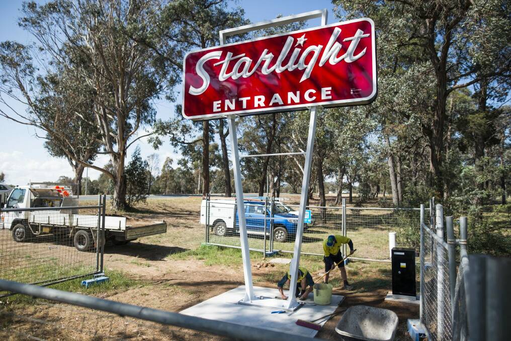 Workers put the final touches on the restored Starlight drive-in sign on Monday. Photo: Rohan Thomson