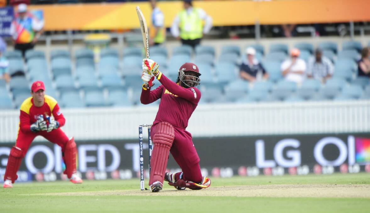 The West Indies' Chris Gayle on his way to setting his record score, but few were in the stands to see him do it. Photo: Melissa Adams