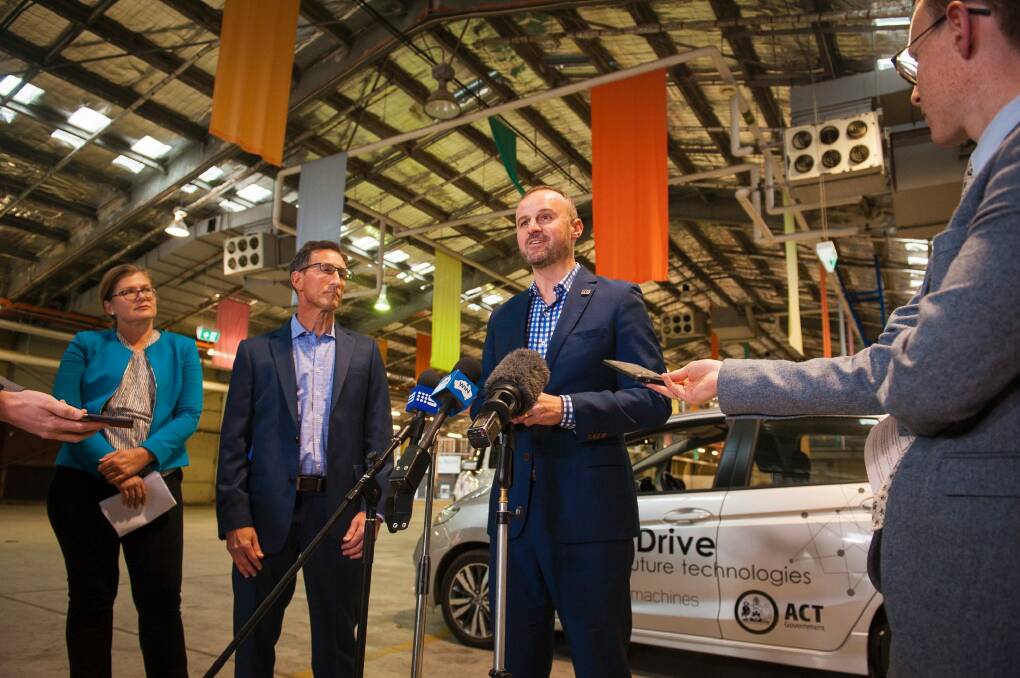 Chief Minister Andrew Barr, with Ken Kroeger of Seeing Machines, centre, and local industry advocate Kate Lundy, left, announcing a driverless car trial on Friday. Photo: Dion Georgopoulos