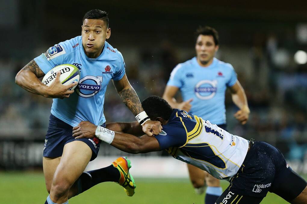 Escape act: Israel Folau fends off a tackle. Photo: Getty Images