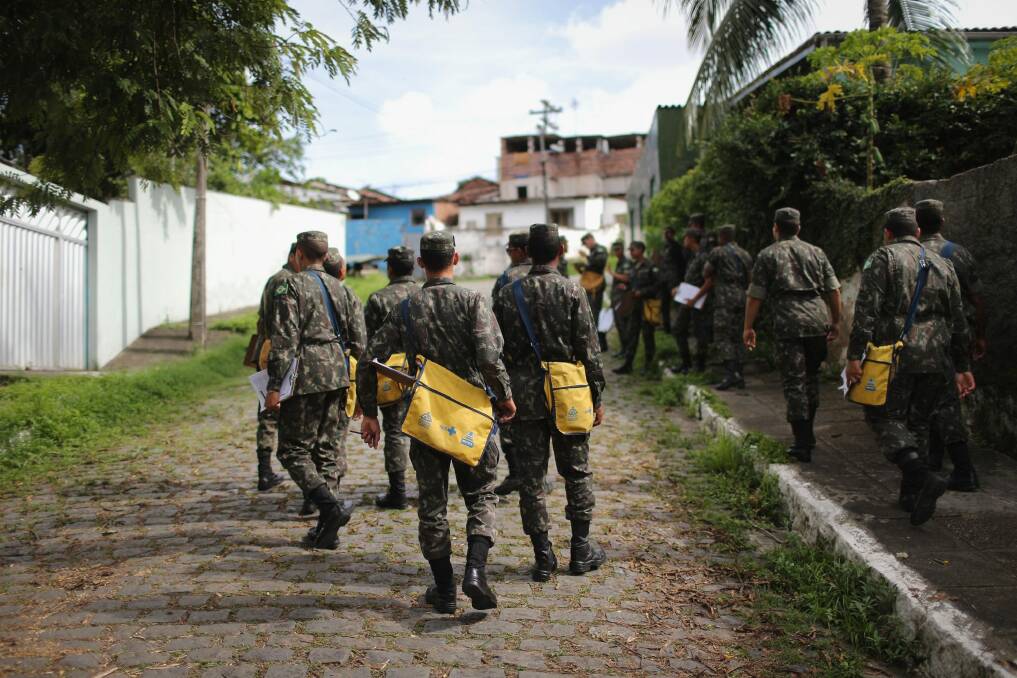 Brazilian soldiers canvass a neighbourhood to tell residents to prevent mosquito bites. Photo: Mario Tama