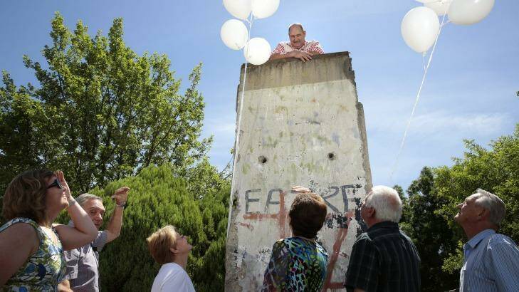 Harmonie German Club president Hans Stoehr on top of a section of the Berlin Wall at the club. Photo: Jeffrey Chan